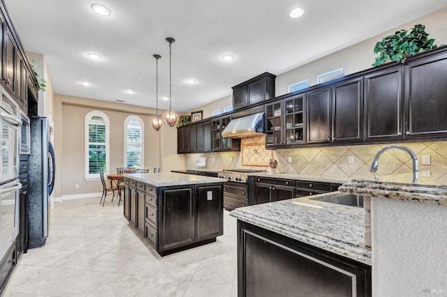 819 Bridle Ridge Dr, Fairfield, CA 94534 - kitchen featuring light stone countertops, backsplash, recessed lighting, baseboards, and pendant lighting