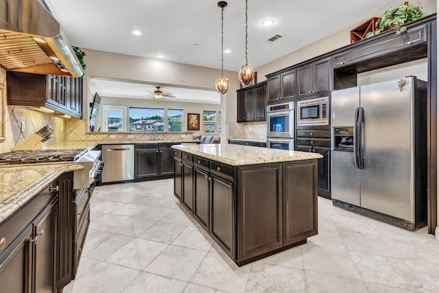 819 Bridle Ridge Dr, Fairfield, CA 94534 - kitchen with appliances with stainless steel finishes, wall chimney range hood, tasteful backsplash, light stone counters, and ceiling fan