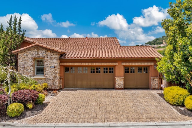 819 Bridle Ridge Dr, Fairfield, CA 94534 - view of front of house featuring stone siding, an attached garage, and a tiled roof