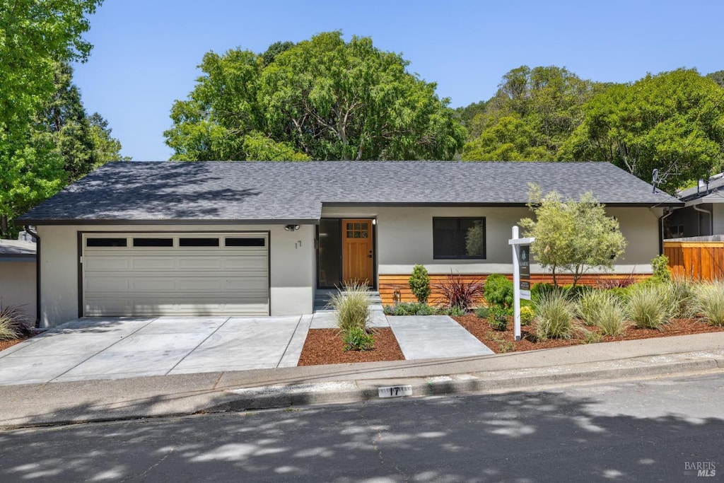 17 San Gabriel Dr, Fairfax, CA 94930 - view of front of house with stucco siding, an attached garage, roof with shingles, and concrete driveway