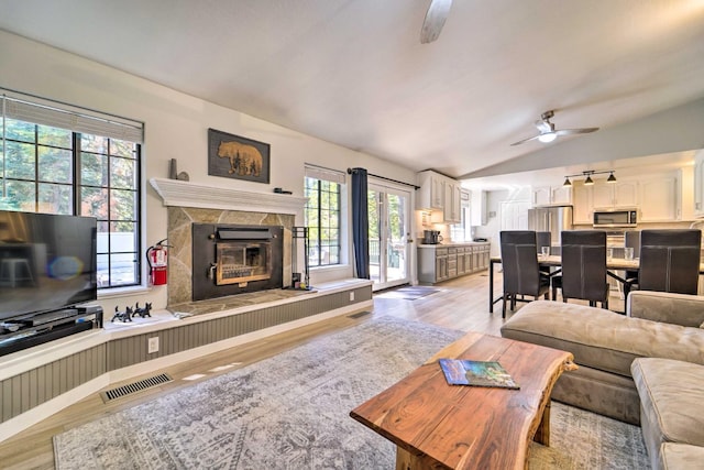 391 Tahoe Woods Blvd, Tahoe City, CA 96145 - living room with lofted ceiling, light wood finished floors, a ceiling fan, and a premium fireplace