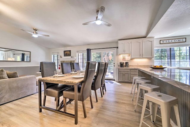 391 Tahoe Woods Blvd, Tahoe City, CA 96145 - dining room featuring ceiling fan, healthy amount of natural light, light wood-style flooring, vaulted ceiling, and wainscoting