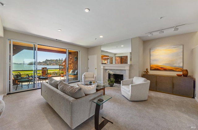1910 Mar W St, Tiburon, CA 94920 - living room featuring light carpet, a high end fireplace, recessed lighting, and a water view