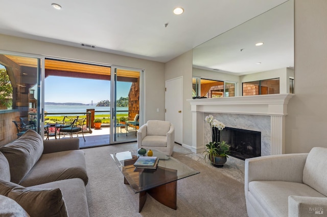1910 Mar W St, Tiburon, CA 94920 - living area with carpet flooring, a fireplace, healthy amount of natural light, a water view, and recessed lighting