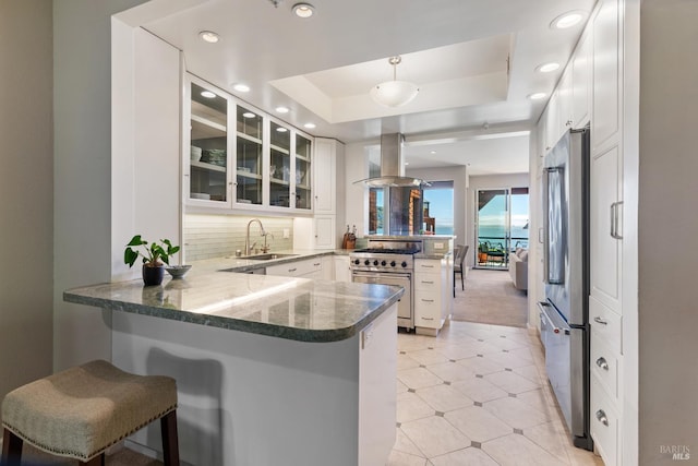 1910 Mar W St, Tiburon, CA 94920 - kitchen with stainless steel appliances, a peninsula, island exhaust hood, a sink, and glass insert cabinets
