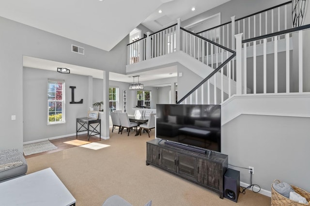 2817 Windmill Dr, Santa Rosa, CA 95403 - carpeted living area with high vaulted ceiling, recessed lighting, baseboards, stairway, and a chandelier