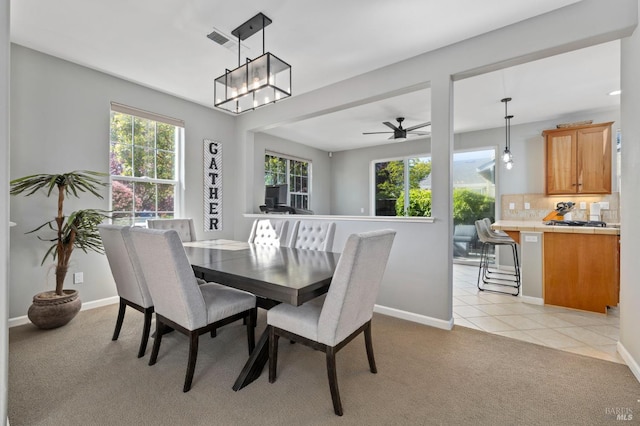 2817 Windmill Dr, Santa Rosa, CA 95403 - dining area with light carpet, a ceiling fan, baseboards, light tile patterned floors, and a chandelier