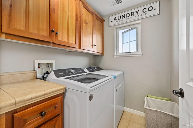 2817 Windmill Dr, Santa Rosa, CA 95403 - washroom with cabinet space, washing machine and clothes dryer, light tile patterned floors, and baseboards
