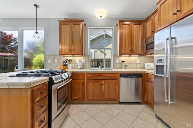 2817 Windmill Dr, Santa Rosa, CA 95403 - kitchen featuring stainless steel appliances, tasteful backsplash, brown cabinetry, and plenty of natural light