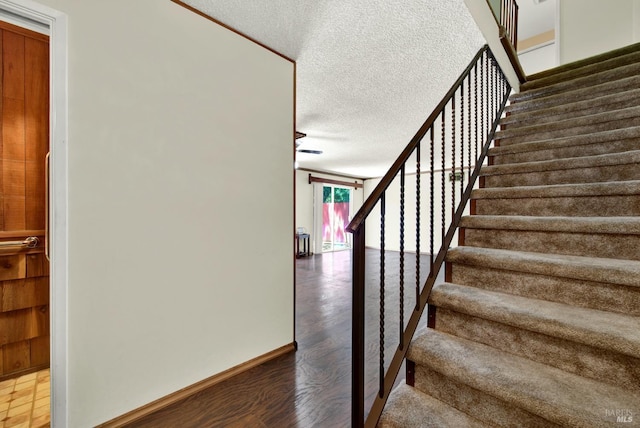970 El Camino Ave Unit 3, Vacaville, CA 95688 - stairway with a textured ceiling, wood finished floors, and baseboards