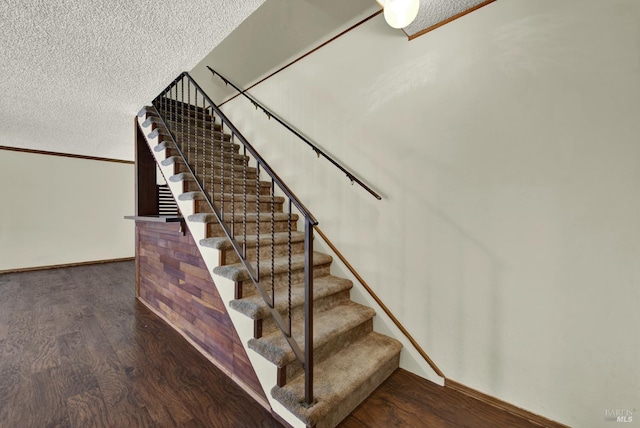 970 El Camino Ave Unit 3, Vacaville, CA 95688 - staircase featuring wood finished floors, a textured ceiling, and baseboards