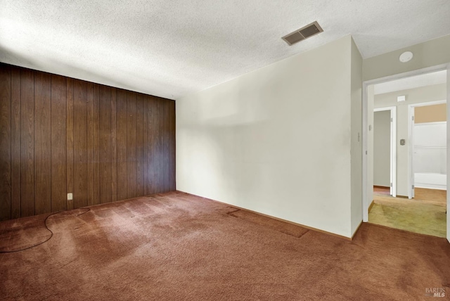 970 El Camino Ave Unit 3, Vacaville, CA 95688 - carpeted empty room featuring wooden walls and a textured ceiling