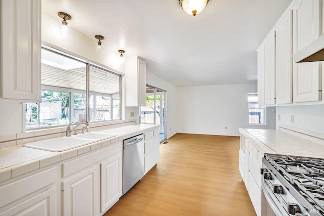 5705 Dexter Cir, Rohnert Park, CA 94928 - kitchen featuring appliances with stainless steel finishes, tile countertops, and white cabinetry