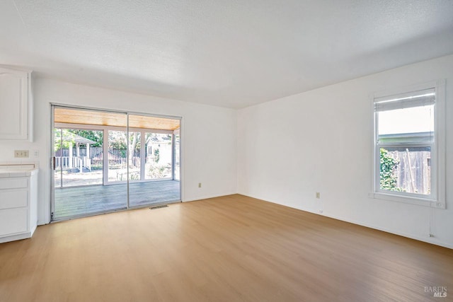 5705 Dexter Cir, Rohnert Park, CA 94928 - unfurnished room with light wood-type flooring, a textured ceiling, and baseboards