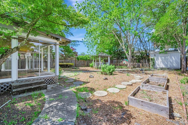 5705 Dexter Cir, Rohnert Park, CA 94928 - fenced backyard featuring a sunroom, a vegetable garden, a storage shed, an outdoor structure, and a gazebo