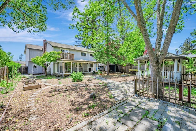 5705 Dexter Cir, Rohnert Park, CA 94928 - rear view of property featuring a vegetable garden, a balcony, and a chimney