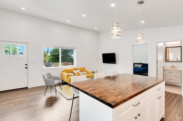 33 Romine Way, Vallejo, CA 94591 - kitchen featuring butcher block countertops, wood finished floors, open floor plan, a kitchen breakfast bar, and recessed lighting