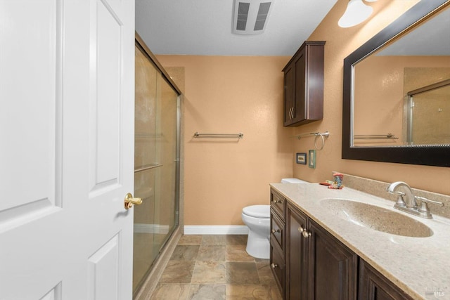 2648 Nut Tree Rd, Vacaville, CA 95687 - bathroom featuring baseboards, a shower stall, vanity, toilet, and stone finish flooring