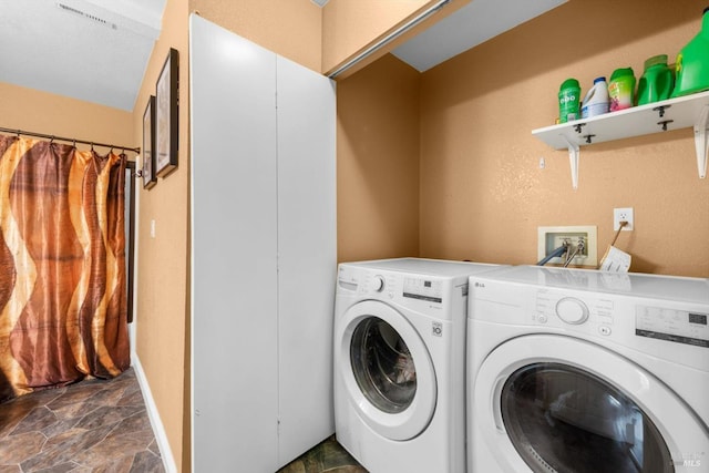 2648 Nut Tree Rd, Vacaville, CA 95687 - laundry area with stone finish floors and separate washer and dryer