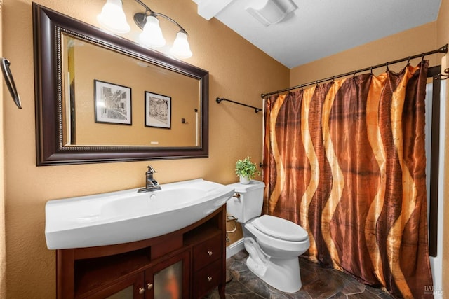 2648 Nut Tree Rd, Vacaville, CA 95687 - bathroom featuring toilet, vanity, and stone finish floors