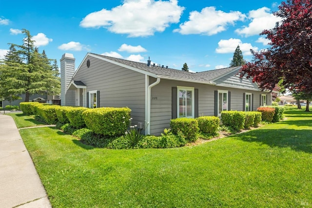 2648 Nut Tree Rd, Vacaville, CA 95687 - view of home's exterior featuring a lawn and a chimney