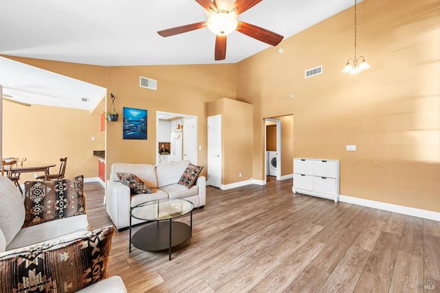 2648 Nut Tree Rd, Vacaville, CA 95687 - living area featuring ceiling fan, washer / dryer, wood finished floors, baseboards, and a chandelier