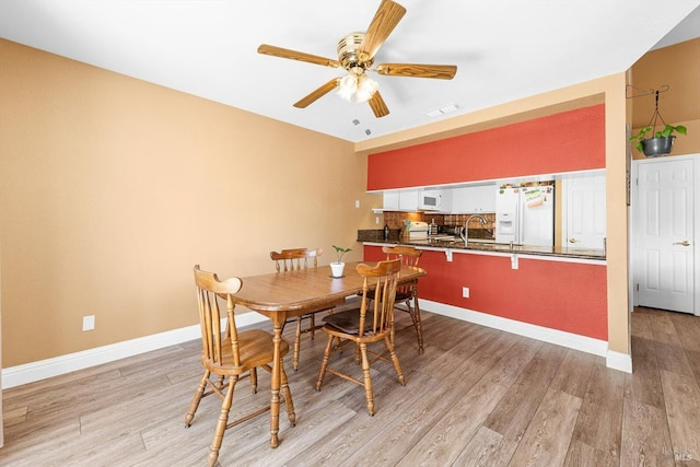 2648 Nut Tree Rd, Vacaville, CA 95687 - dining area featuring light wood-style floors, ceiling fan, and baseboards