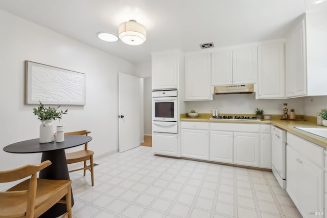 1400 High School Rd, Sebastopol, CA 95472 - kitchen with white appliances, under cabinet range hood, a warming drawer, light flooring, and light countertops