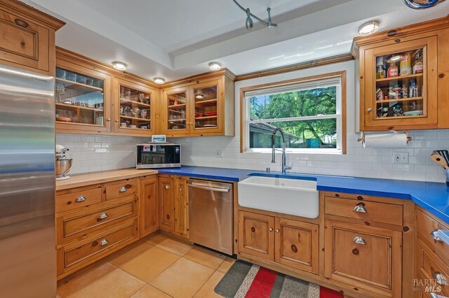 7293 Occidental Rd, Sebastopol, CA 95472 - kitchen featuring stainless steel appliances, a sink, light tile patterned flooring, and tasteful backsplash