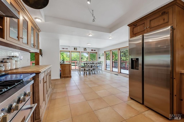 7293 Occidental Rd, Sebastopol, CA 95472 - kitchen featuring stainless steel appliances, backsplash, light tile patterned floors, glass insert cabinets, and a raised ceiling