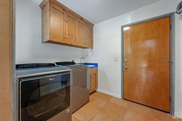 7293 Occidental Rd, Sebastopol, CA 95472 - clothes washing area featuring independent washer and dryer, cabinet space, and baseboards