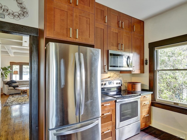 1011 Georgia St, Vallejo, CA 94590 - kitchen with stainless steel appliances, dark wood finished floors, dark countertops, brown cabinets, and coffered ceiling