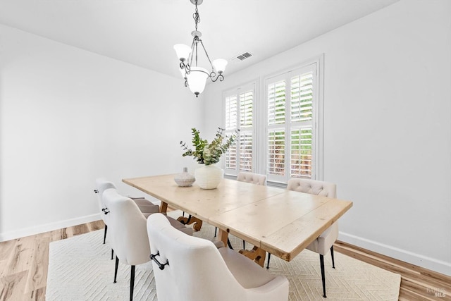 201 Red Pheasant Dr, Vacaville, CA 95687 - dining space featuring a chandelier, baseboards, and light wood-style floors