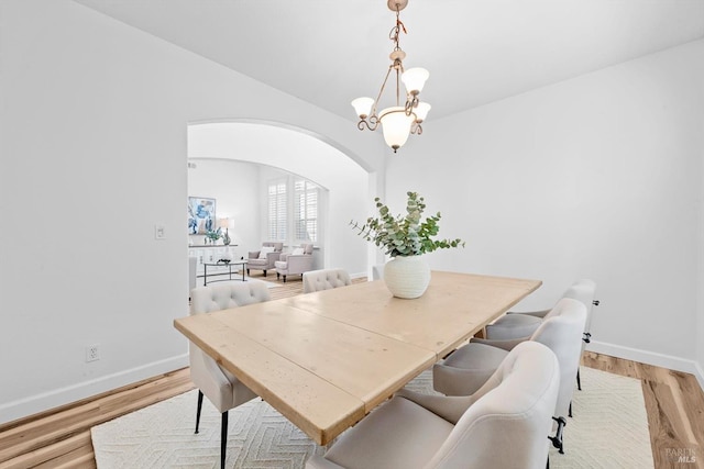 201 Red Pheasant Dr, Vacaville, CA 95687 - dining space with arched walkways, light wood-style flooring, and baseboards