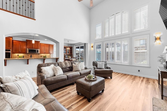 201 Red Pheasant Dr, Vacaville, CA 95687 - living room with a high ceiling, light wood finished floors, ceiling fan, healthy amount of natural light, and arched walkways