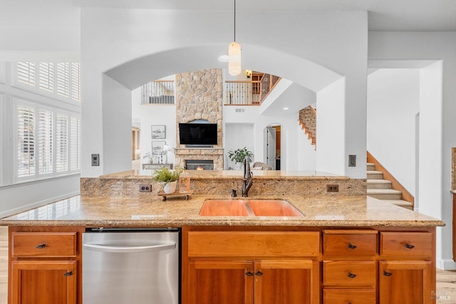201 Red Pheasant Dr, Vacaville, CA 95687 - kitchen with stainless steel dishwasher, a sink, light stone countertops, arched walkways, and open floor plan