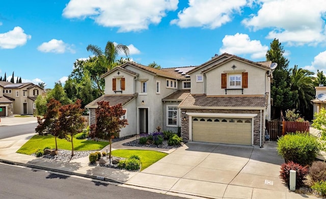 201 Red Pheasant Dr, Vacaville, CA 95687 - view of front of house featuring a garage, stone siding, driveway, solar panels, and stucco siding