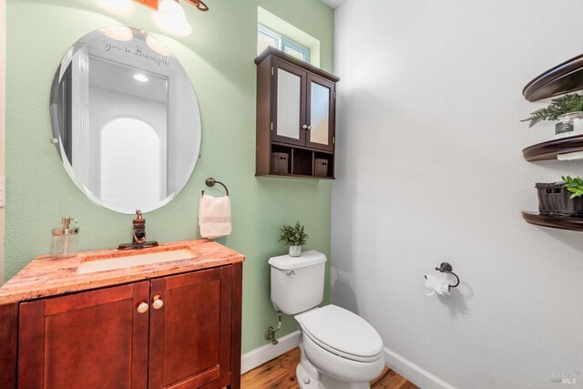 201 Red Pheasant Dr, Vacaville, CA 95687 - half bathroom with wood finished floors, toilet, vanity, and baseboards