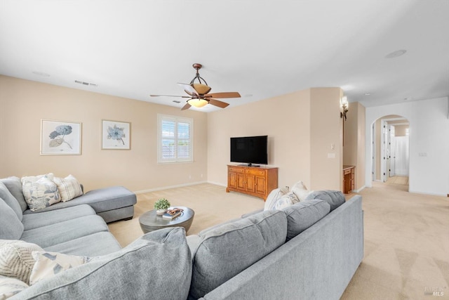 201 Red Pheasant Dr, Vacaville, CA 95687 - living area with arched walkways, light carpet, ceiling fan, and baseboards