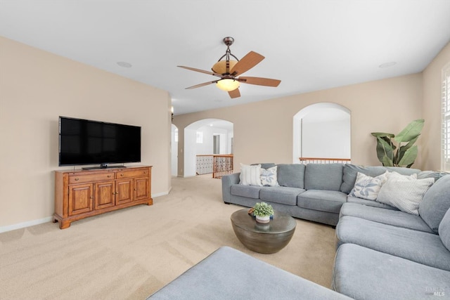 201 Red Pheasant Dr, Vacaville, CA 95687 - living room featuring arched walkways, a ceiling fan, light carpet, and baseboards