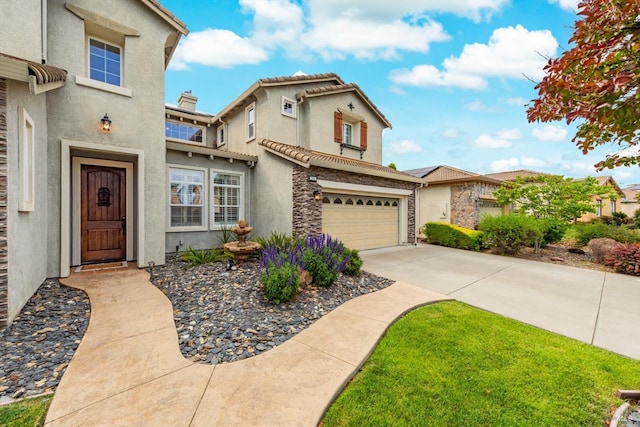 201 Red Pheasant Dr, Vacaville, CA 95687 - view of front of home featuring an attached garage, stucco siding, concrete driveway, stone siding, and a tiled roof