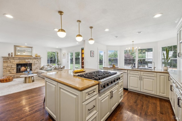 9724 Green Valley Rd, Sebastopol, CA 95472 - kitchen with stainless steel gas cooktop, a sink, dark wood-style floors, recessed lighting, and a fireplace