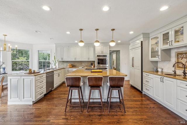 9724 Green Valley Rd, Sebastopol, CA 95472 - kitchen featuring a sink, appliances with stainless steel finishes, a kitchen island, recessed lighting, and glass insert cabinets