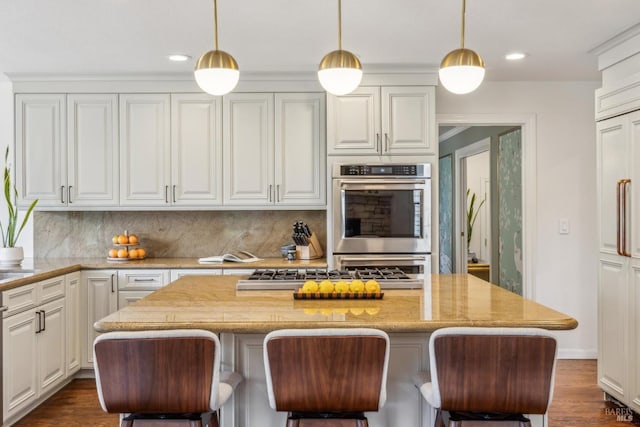 9724 Green Valley Rd, Sebastopol, CA 95472 - kitchen featuring appliances with stainless steel finishes, decorative backsplash, white cabinetry, recessed lighting, and a kitchen bar