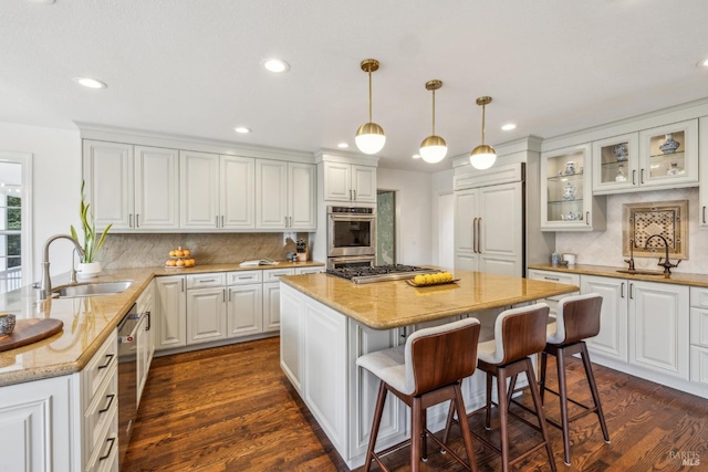 9724 Green Valley Rd, Sebastopol, CA 95472 - kitchen with a sink, appliances with stainless steel finishes, a breakfast bar area, glass insert cabinets, and recessed lighting
