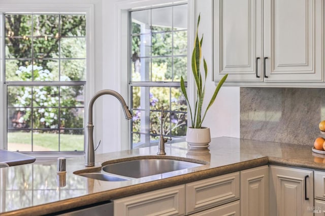 9724 Green Valley Rd, Sebastopol, CA 95472 - kitchen featuring a sink, backsplash, white cabinetry, and stone countertops