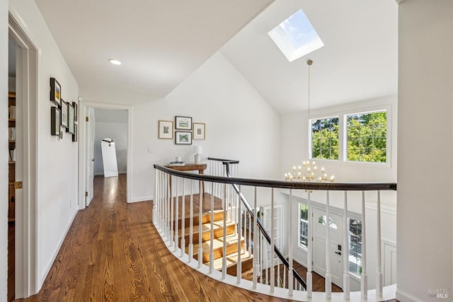 9724 Green Valley Rd, Sebastopol, CA 95472 - corridor featuring an upstairs landing, a skylight, a chandelier, wood finished floors, and baseboards