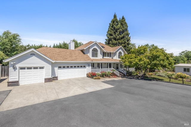 9724 Green Valley Rd, Sebastopol, CA 95472 - view of front facade featuring a porch, driveway, an attached garage, and a chimney