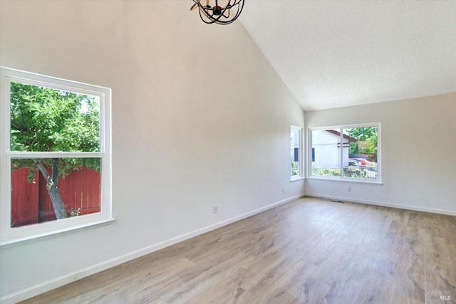 181 Belvedere Ct, Vallejo, CA 94589 - empty room with wood finished floors, high vaulted ceiling, a chandelier, and baseboards