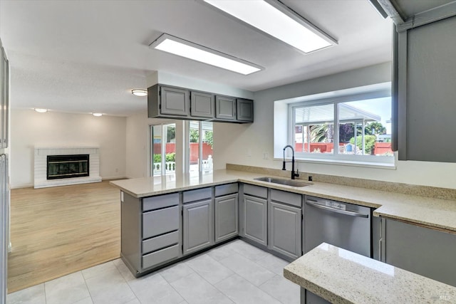 181 Belvedere Ct, Vallejo, CA 94589 - kitchen featuring a sink, gray cabinetry, a peninsula, and stainless steel dishwasher